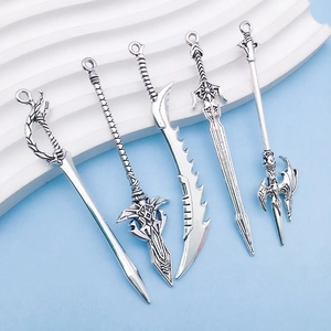 Detailed view of five vintage silver alloy sword charms with intricate antique textures