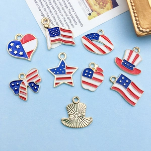 Detailed flat lay of American flag enamel charms in heart and star shapes for DIY jewelry