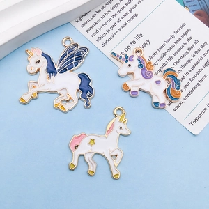Detailed close-up of colorful enamel unicorn pendants for DIY jewelry making