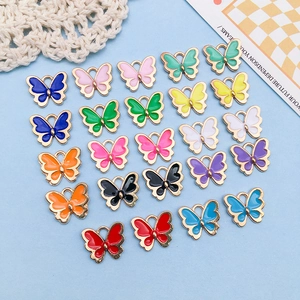 Close-up of twenty colorful alloy butterfly pendants for DIY handmade jewelry crafts
