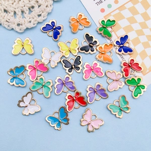 Macro shot of colorful enamel butterfly alloy pendants for DIY jewelry crafting