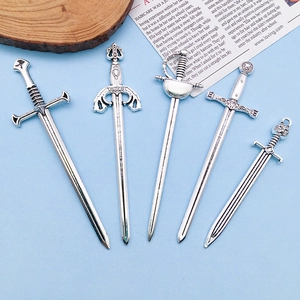 Detail view of five vintage silver sword pendants with intricate medieval patterns