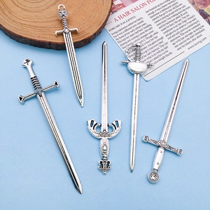Detail view of five vintage silver sword charms including a Gladiator engraved alloy pendant