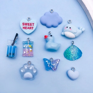 Blue resin charm collection with dolphin, butterfly, and candy shapes for DIY bracelets