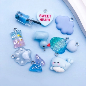 Detailed set of 10 blue resin charms featuring sweet hearts, ducks, and cartoon dolphins
