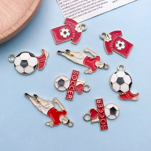 Macro detail of DIY soccer enamel charms including red jersey and gold alloy pendants