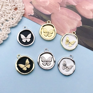 Macro detail of alloy butterfly wax seal pendants for DIY jewelry necklace design
