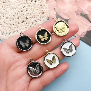 Macro shot of butterfly wax seal charms in gold and silver finishes for DIY jewelry