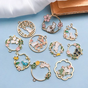 Detailaufnahme von 10 Emaille-Katzenanhängern mit Blumenkranz und Strass-Akzenten
