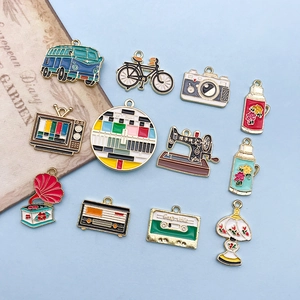 Detailed set of 12 vintage enamel alloy charms including a bus, camera and sewing machine