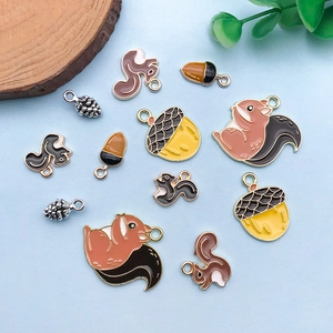 Flat lay of colorful enamel squirrel and acorn charms for DIY jewelry making