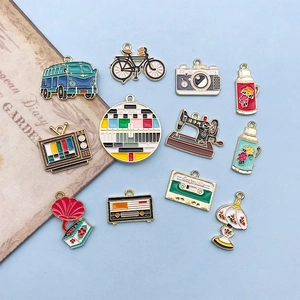 Detailed flat lay of vintage alloy charms featuring a retro camera, radio, and sewing machine