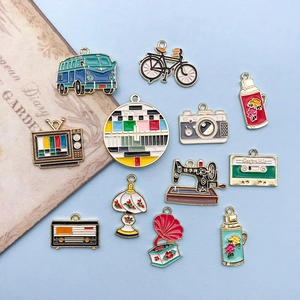 Set of 12 vintage enamel alloy charms including retro camera bus and sewing machine