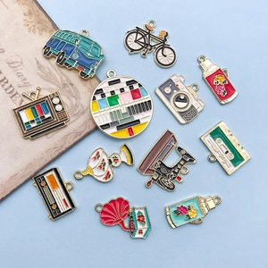 Set of 12 vintage enamel alloy charms featuring retro designs like cameras and sewing machines