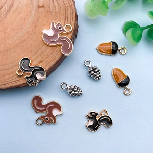 Detailed close-up of squirrel and acorn alloy charms for DIY jewelry making sets