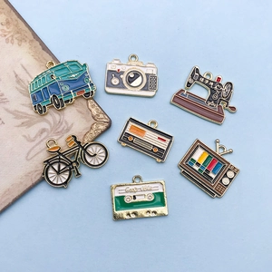 Macro detail of retro enamel charms including sewing machine and camera for DIY jewelry