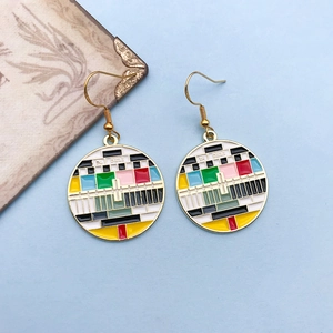 Close-up of retro color bar pendant earrings with gold finish and pop art design
