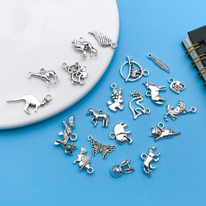 Close-up of assorted antique silver animal pendants and charms for DIY jewelry making