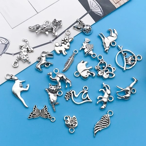 Detailed macro view of vintage silver animal alloy charms for DIY jewelry crafting