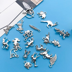 Detailed flat lay of antique silver animal charms for DIY necklace and bracelet crafting