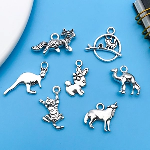 Detail of seven antique silver animal charms including fox and rabbit for DIY jewelry