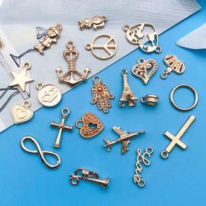 Close-up of mixed golden alloy charms including stars and hearts for DIY jewelry making