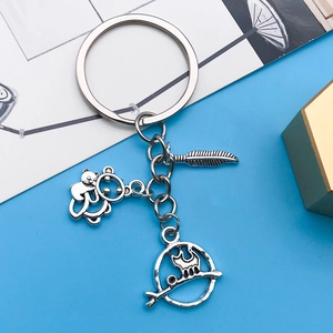 Detailed macro view of vintage silver animal, feather and cat silhouette alloy pendants