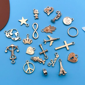 Assorted gold alloy charms featuring Eiffel Tower, heart, and crown designs for DIY jewelry