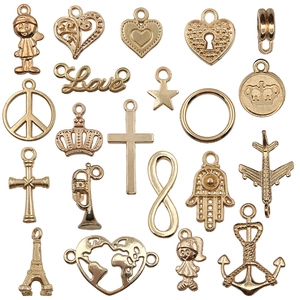 Assorted gold alloy DIY travel charms including heart, anchor, and Eiffel Tower shapes