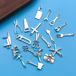 Vue macro de 20 breloques assorties en alliage argenté antique pour la création de bijoux DIY