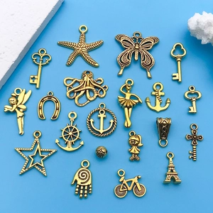Detailed macro view of assorted antique gold alloy charms for DIY jewelry crafting projects