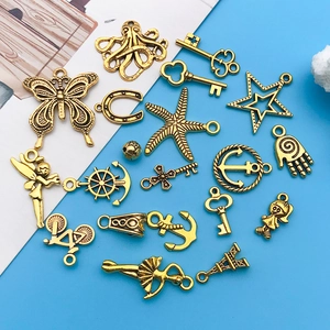 Vintage gold alloy charms set featuring butterfly, anchor, and key for DIY jewelry making
