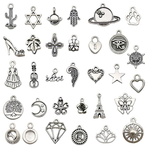 Set of 29 vintage silver alloy charms with butterfly, heart and tree motifs for DIY jewelry