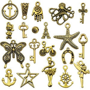 Assorted vintage gold alloy charms including anchor and butterfly for DIY jewelry making