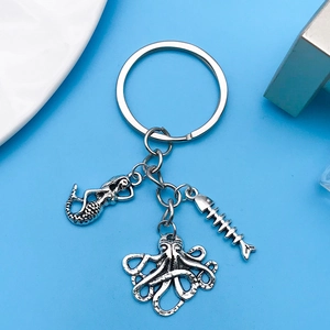Detail of silver alloy keychain with mermaid, octopus and fishbone nautical charms