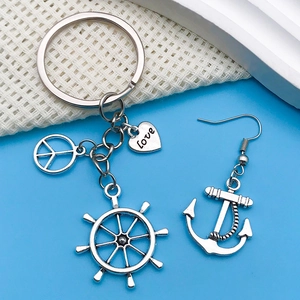 Macro detail of nautical alloy charms set featuring ship wheel, anchor and heart patterns