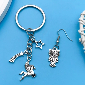 Detailed shot of vintage silver charms including pegasus, star, and owl jewelry pieces
