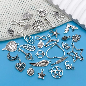 Various antique silver alloy charms for jewelry making featuring diverse vintage designs
