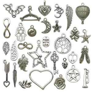 Collection of 30 vintage silver alloy charms featuring wings, hot air balloons and hearts