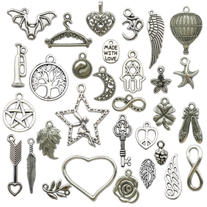 Set of 26 antique silver alloy charms including hearts, trees, and moon for DIY jewelry