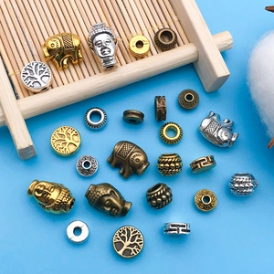 Macro shot of assorted alloy spacer beads in vintage gold, silver, and bronze finishes