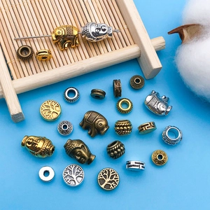 Detailed top view of assorted vintage alloy spacer beads with ethnic patterns for DIY jewelry