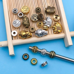 Macro shot of assorted metal alloy spacer beads for DIY jewelry making in antique finishes