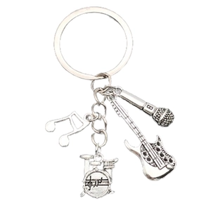Detail of silver musical keychain featuring guitar, drum kit, microphone and note charms