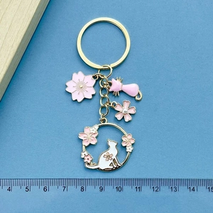 Cute pink cherry blossom and cat keychain in gold alloy finish with enamel charms