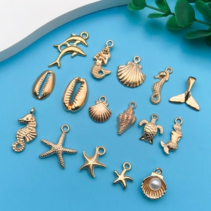 Detailed view of assorted KC gold-plated marine animal charms for DIY bracelet making