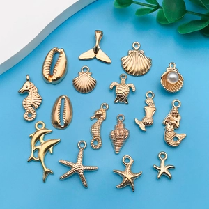 Detail view of 16 gold plated ocean animal charms for DIY jewelry making and crafts