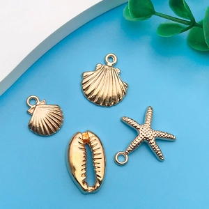 Golden sea animal charms featuring starfish and shell designs for DIY jewelry making