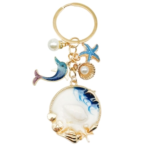 Ocean theme keychain with dolphin, starfish, shell charms and blue fluid resin pendant