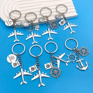 Silver travel keychain set with airplane compass globe and anchor charms for travelers